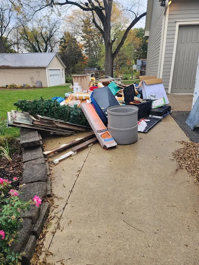 Dumpster being loaded with debris for 10 Yard Dumpster Rental in Adamsville